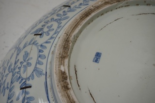 A large Japanese blue and white decorated charger, 47cm diameter. Condition - riveted and chips to rim